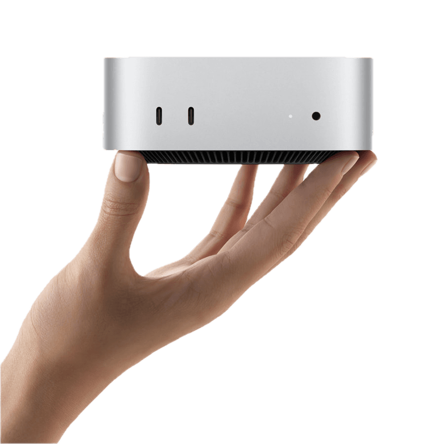 A hand holding a Mac mini